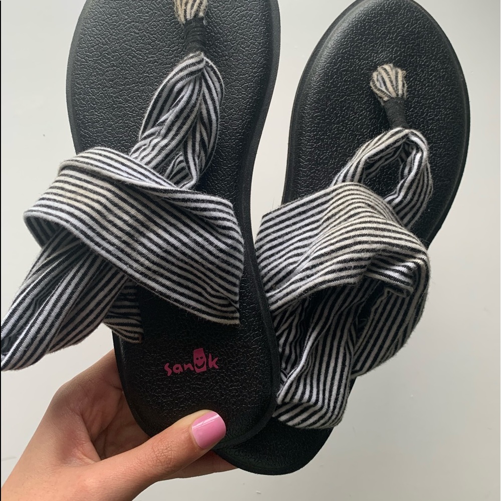 Black and white striped sanuk’s.